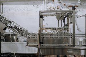 Automated beverage can packaging in a modern factory setting.